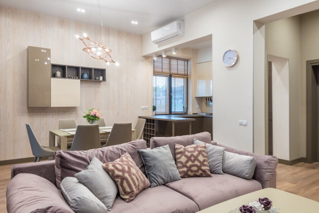 Modern living room and dining area with elegant decor and ample natural light.